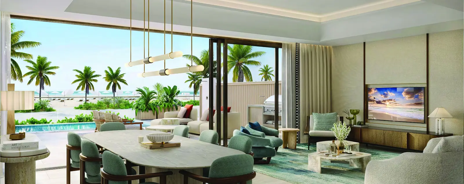 Townhouse living and dining room at Fairmont Residences Al Marjan Island, opening to a terrace with pool and palm-lined beach
